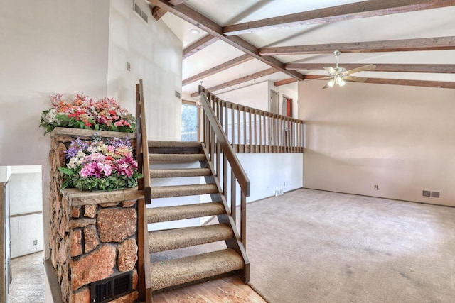 staircase featuring visible vents, beamed ceiling, and high vaulted ceiling