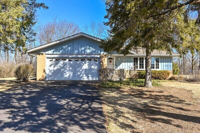 ranch-style home with an attached garage and driveway