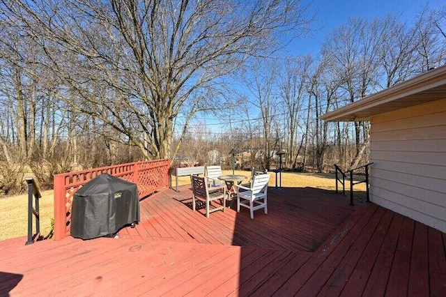 wooden deck featuring outdoor dining area and a grill