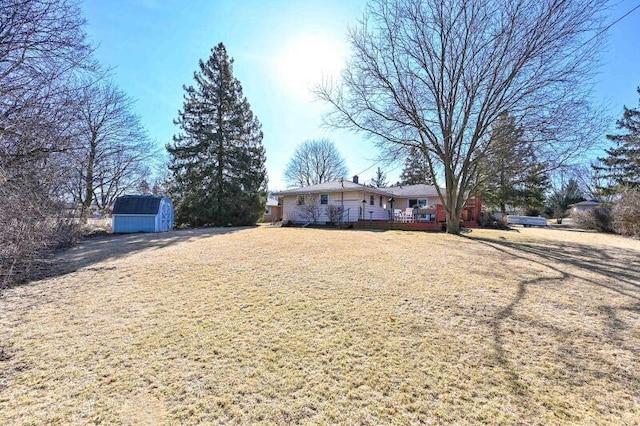 view of front of home with a storage shed and an outdoor structure