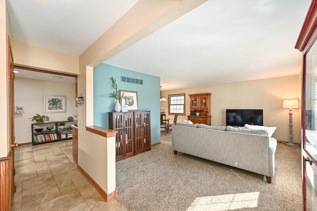 living room featuring baseboards and visible vents