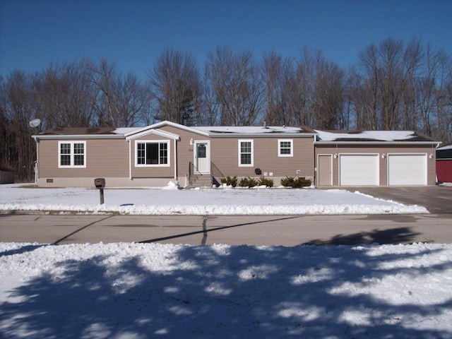 manufactured / mobile home featuring crawl space, entry steps, and a garage