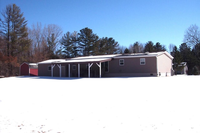 snow covered house with crawl space