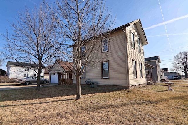 view of property exterior featuring a lawn and a garage