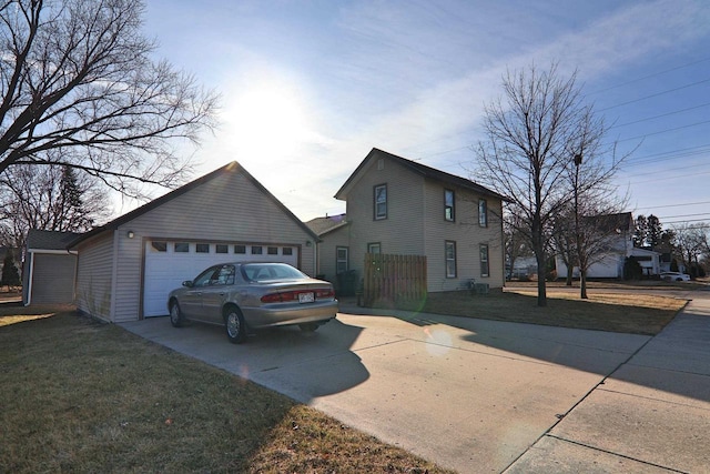 view of property exterior featuring a lawn and a garage