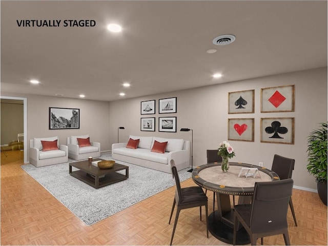 living area featuring recessed lighting, visible vents, and baseboards