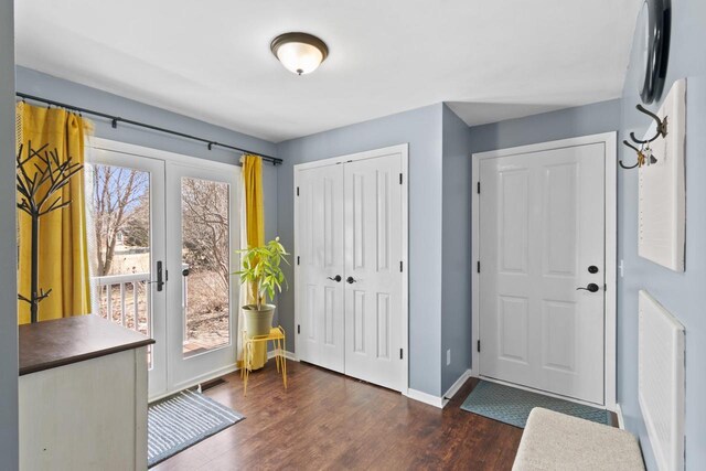 entrance foyer with dark wood-style floors, visible vents, and baseboards