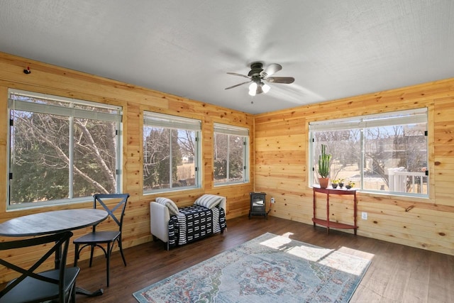 living area featuring wood walls and hardwood / wood-style floors