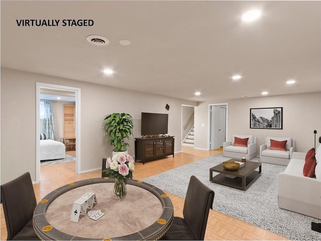 living room featuring recessed lighting, visible vents, baseboards, and stairs