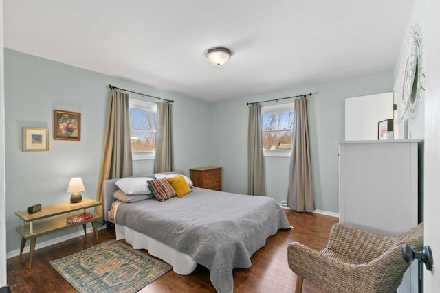 bedroom featuring wood finished floors and baseboards