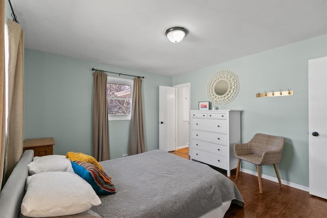 bedroom with wood finished floors and baseboards