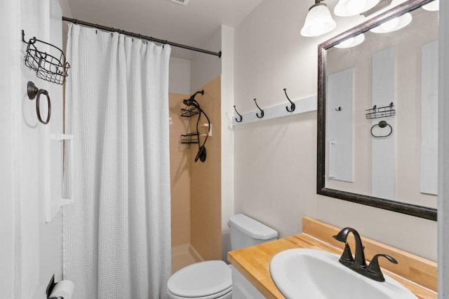 bathroom featuring a shower with shower curtain, toilet, and vanity