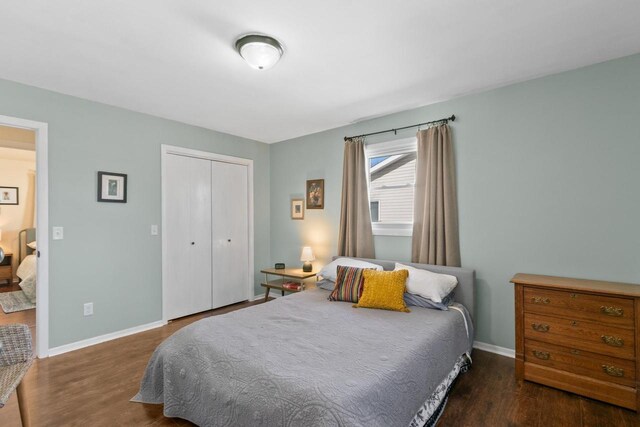 bedroom with a closet, baseboards, and wood finished floors