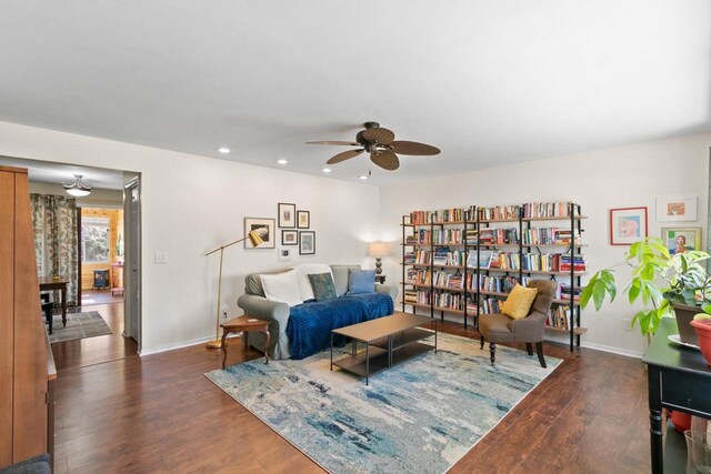 living area with ceiling fan, baseboards, wood finished floors, and recessed lighting