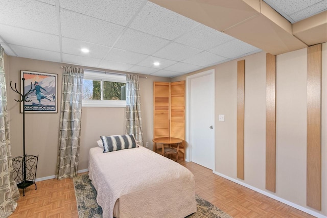 bedroom with recessed lighting, baseboards, and a drop ceiling