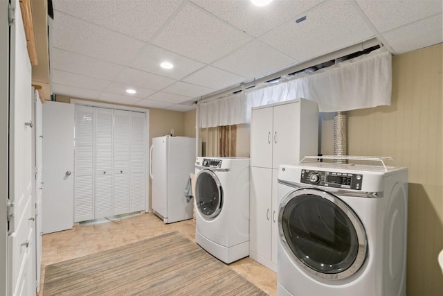 laundry area featuring laundry area, light floors, and separate washer and dryer