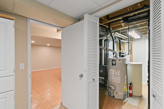 utility room featuring gas water heater