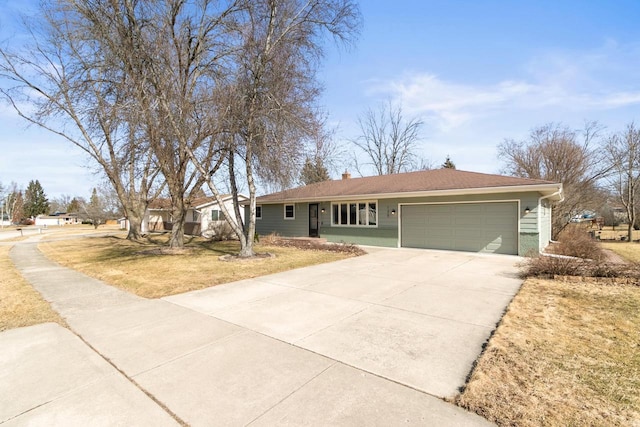 single story home with a garage, a front yard, a chimney, and driveway