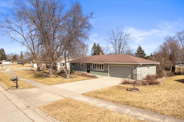 single story home featuring a front yard, a garage, and driveway