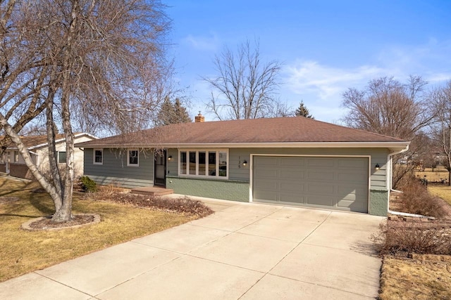 ranch-style house with a chimney, concrete driveway, and an attached garage