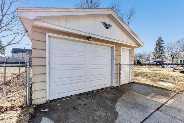 detached garage with aphalt driveway and fence