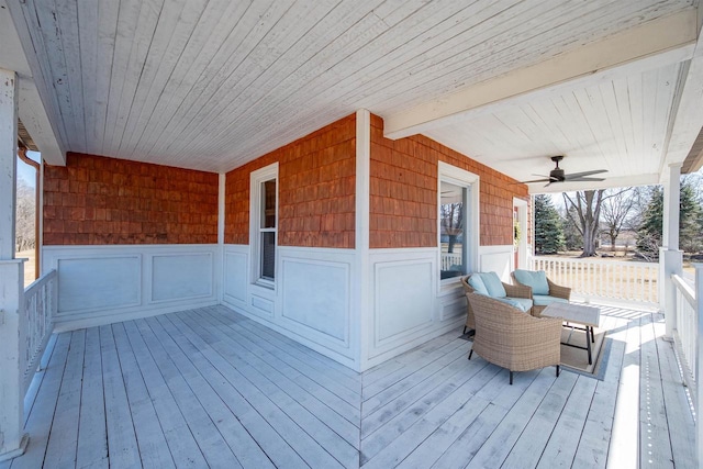 wooden terrace with a ceiling fan