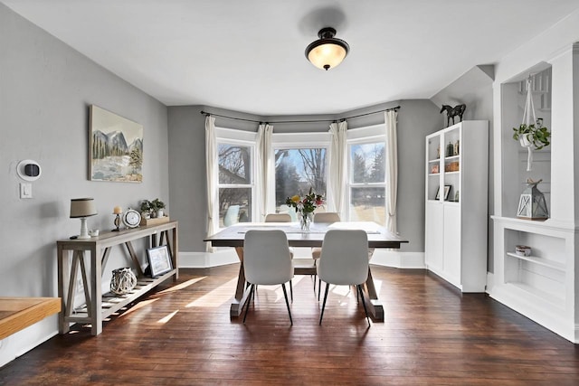 dining area featuring baseboards and hardwood / wood-style flooring