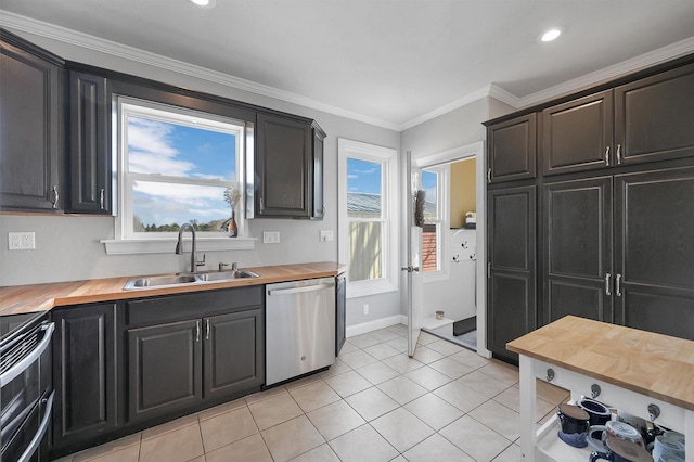 kitchen with dishwasher, wood counters, range with electric stovetop, and a sink