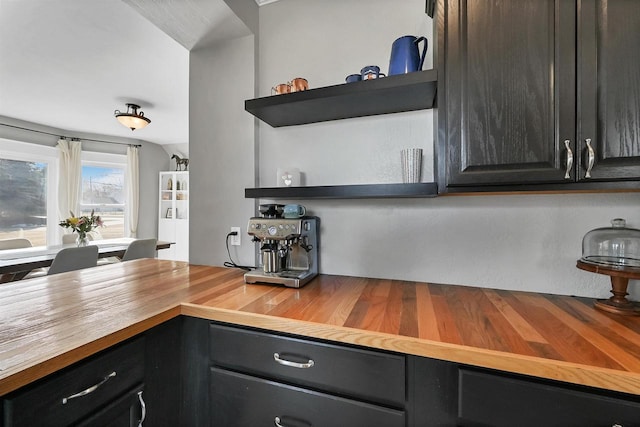 kitchen featuring butcher block countertops and open shelves