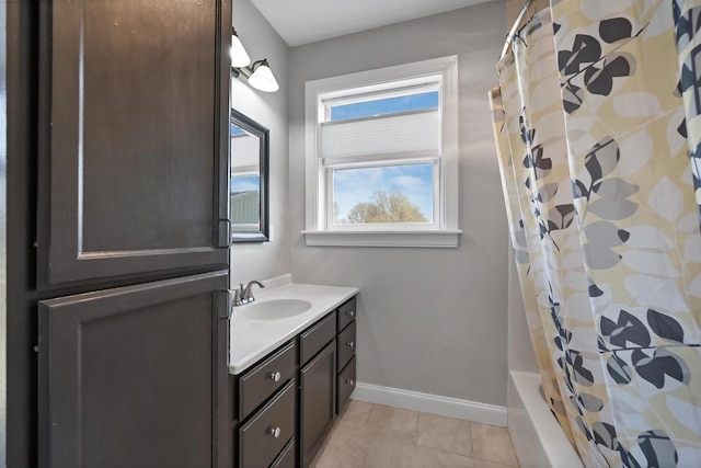 bathroom with tile patterned flooring, vanity, and baseboards