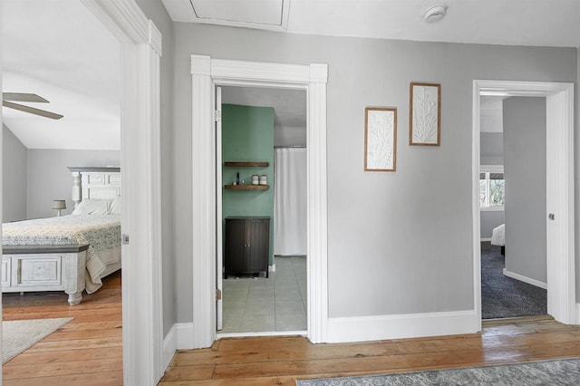 hall featuring baseboards and wood-type flooring