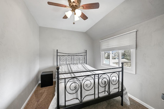 carpeted bedroom with baseboards, lofted ceiling, a ceiling fan, and a textured wall