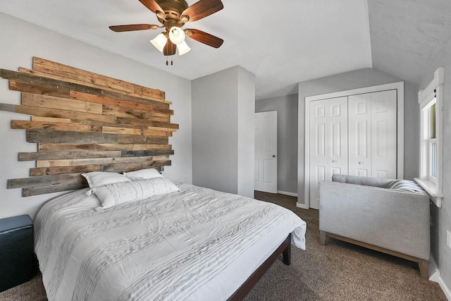 bedroom with a ceiling fan, a closet, carpet floors, baseboards, and vaulted ceiling