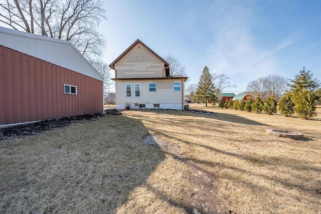 rear view of property with a yard