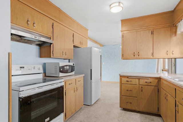 kitchen with white appliances, light countertops, and under cabinet range hood