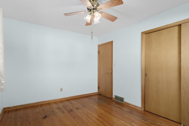 unfurnished bedroom featuring visible vents, light wood-style flooring, and baseboards