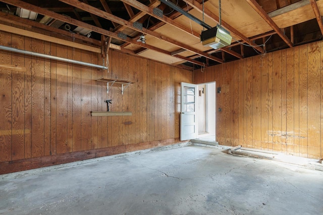 garage featuring wooden walls and a garage door opener