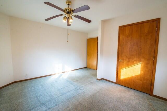 unfurnished bedroom with ceiling fan, baseboards, and carpet floors