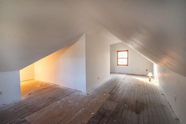 bonus room with lofted ceiling and hardwood / wood-style flooring