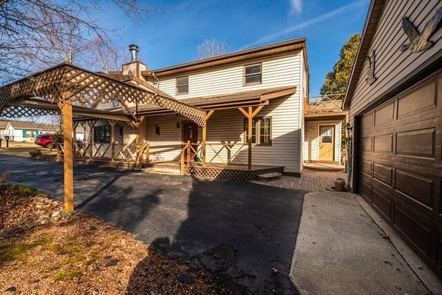 back of property with a garage