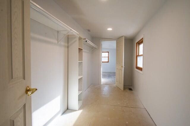 hallway with recessed lighting and a barn door