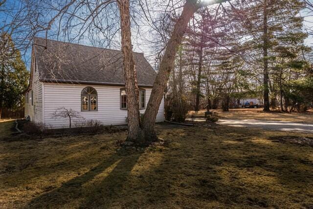 view of side of property with a shingled roof