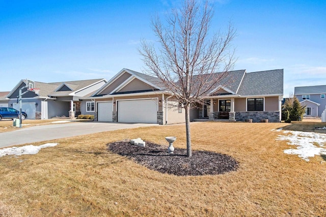 ranch-style house featuring a front lawn, an attached garage, stone siding, and concrete driveway