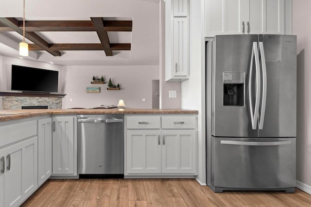 kitchen with stainless steel appliances, coffered ceiling, light wood-style flooring, and white cabinetry