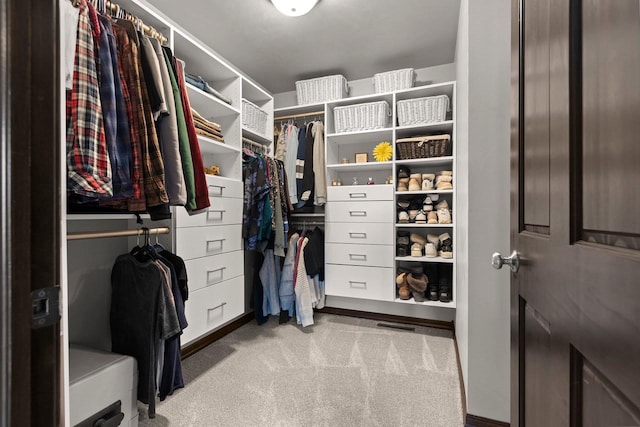 walk in closet featuring carpet floors