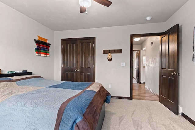 bedroom with light carpet, baseboards, a closet, and a ceiling fan