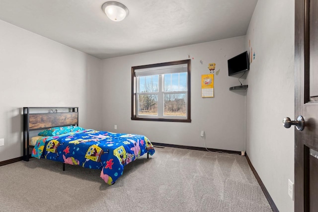 carpeted bedroom featuring baseboards