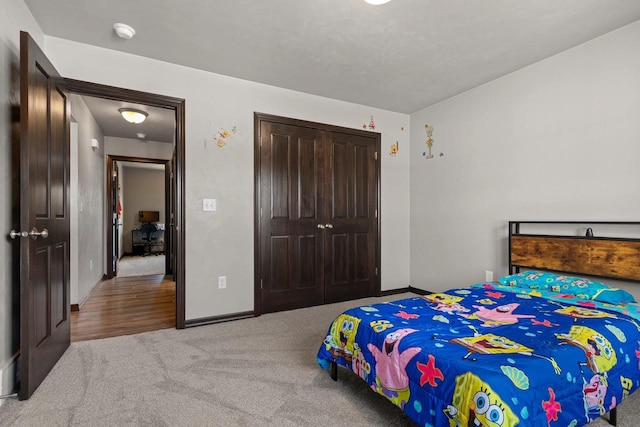 bedroom with a closet, baseboards, and carpet flooring