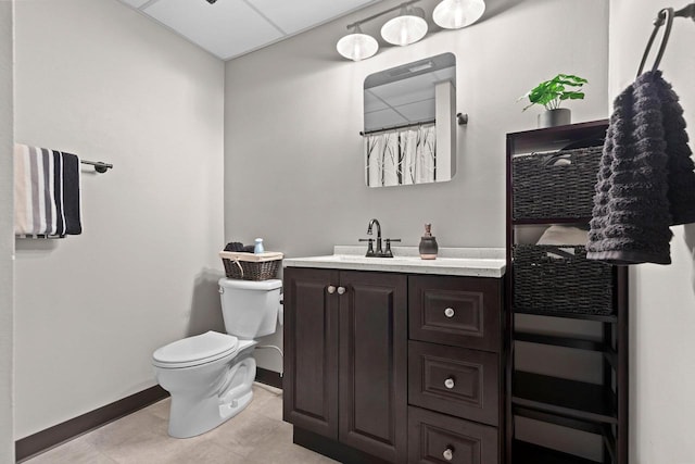 bathroom with vanity, toilet, and baseboards