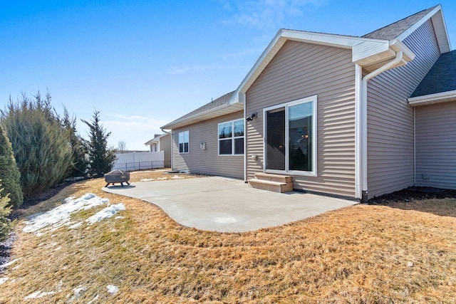 back of property with entry steps, a patio, and fence